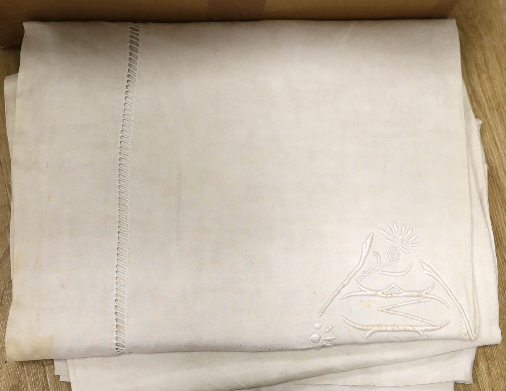 A collection of eight French provincial coarse linen sheets with embroidered and monogrammed turnbacks